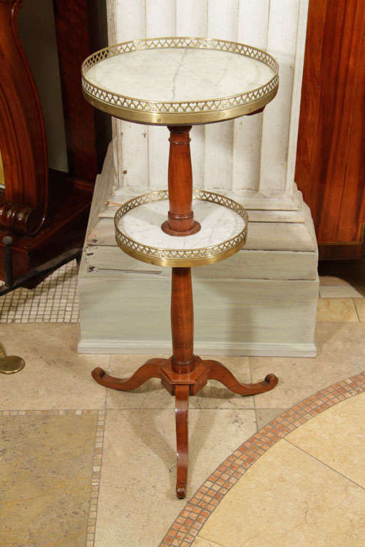 Louis Philippe fruitwood two-tier marble and gilt bronze stand.