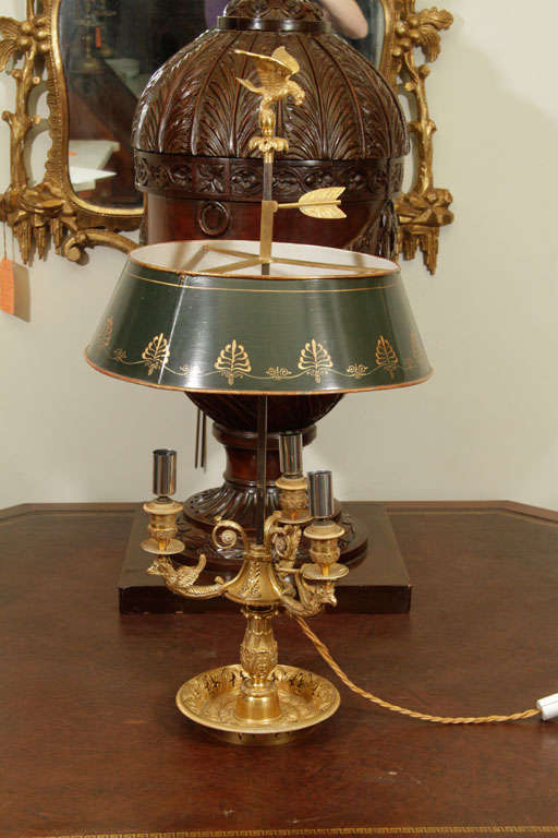 French Empire gilt bronze three-light Bouillotte lamp with eagle finial and arms above a pierced base.