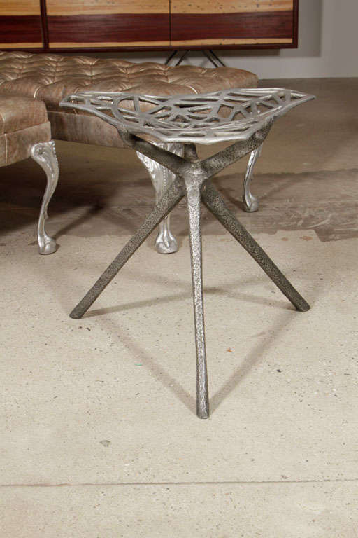 Rare cast aluminum stool by Thomas Lynn, circa mid-1960s. This example has deeply textured sculptural legs with an organic polished aluminum spider web top. It can grace any room as a wonderful object and is a fully functional occasional stool.