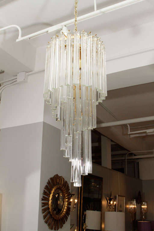A very glamorous five-tier Murano glass foyer chandelier on brass frame.