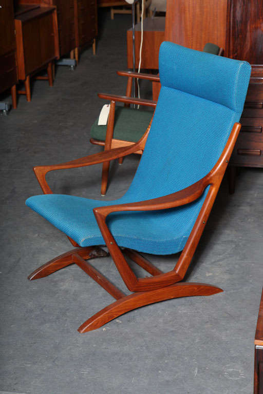 Unusual Teak Danish Modern Highback Rocking Chair.  Features Atomic Era Design Style and Original Fabric.  Base remains steady while the chair frame rocks.