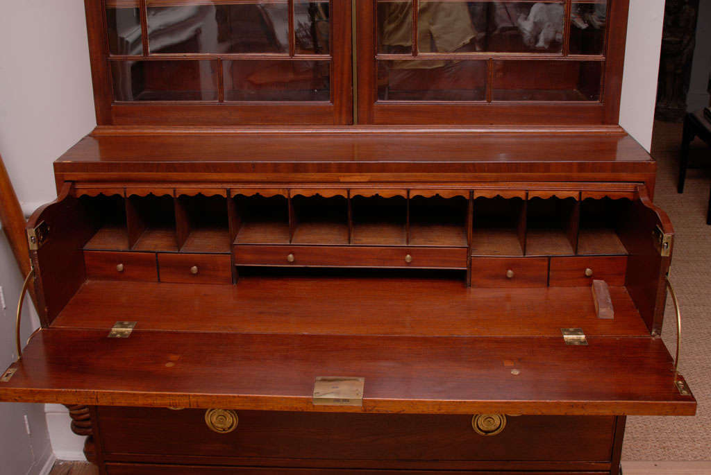 An elegant and simple George III mahogany secretaire bookcase with glazed doors enclosing adjustable shelves, the lower section with drawers and fitted interior.