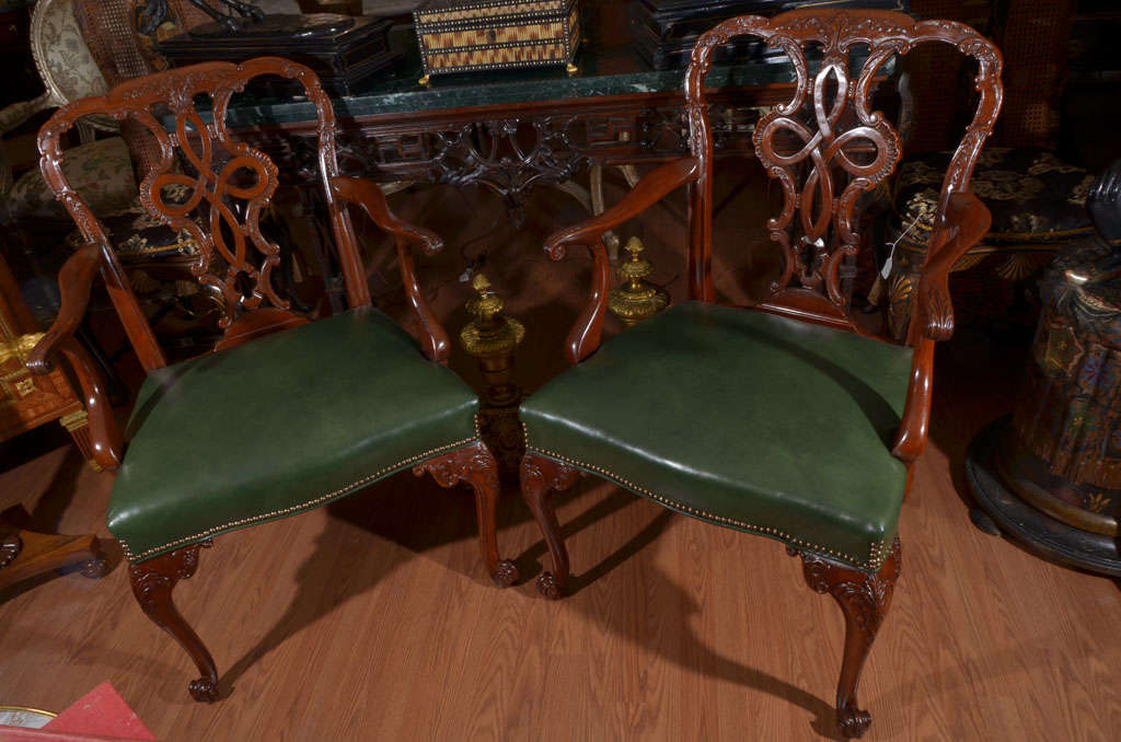 pair of 19th c English mahogany George III armchaairs coverd in green leather
