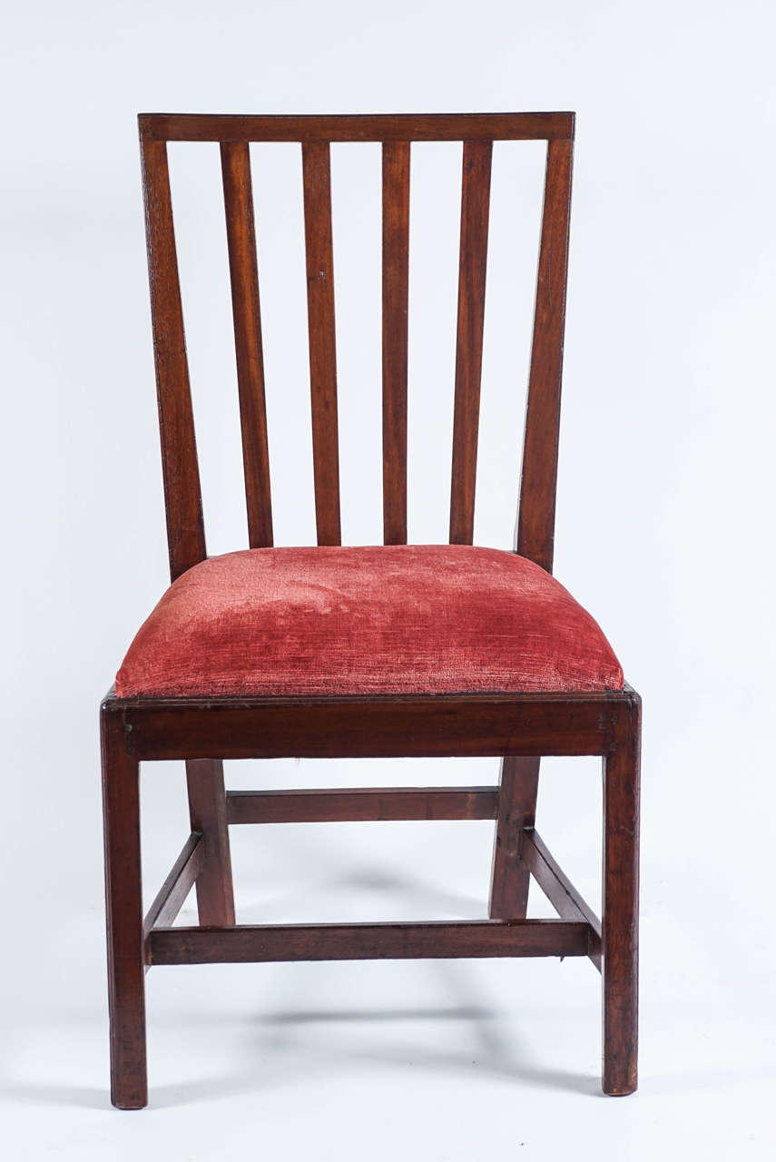 A New York Federal period mahogany side chair of elegantly austere design having rectangular form back-rest with vertical splats, upholstered slip-seat raised on front square legs and splayed rear, united by an H-frame stretcher.  Please see 'The