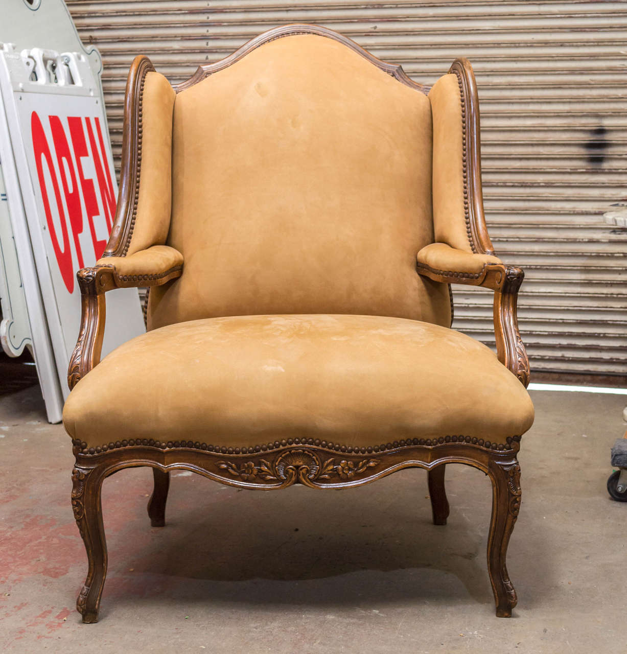 Fabulous early 19th century French walnut wing chair.
Upholstered in ultra suede. Some stains as seen in photos.