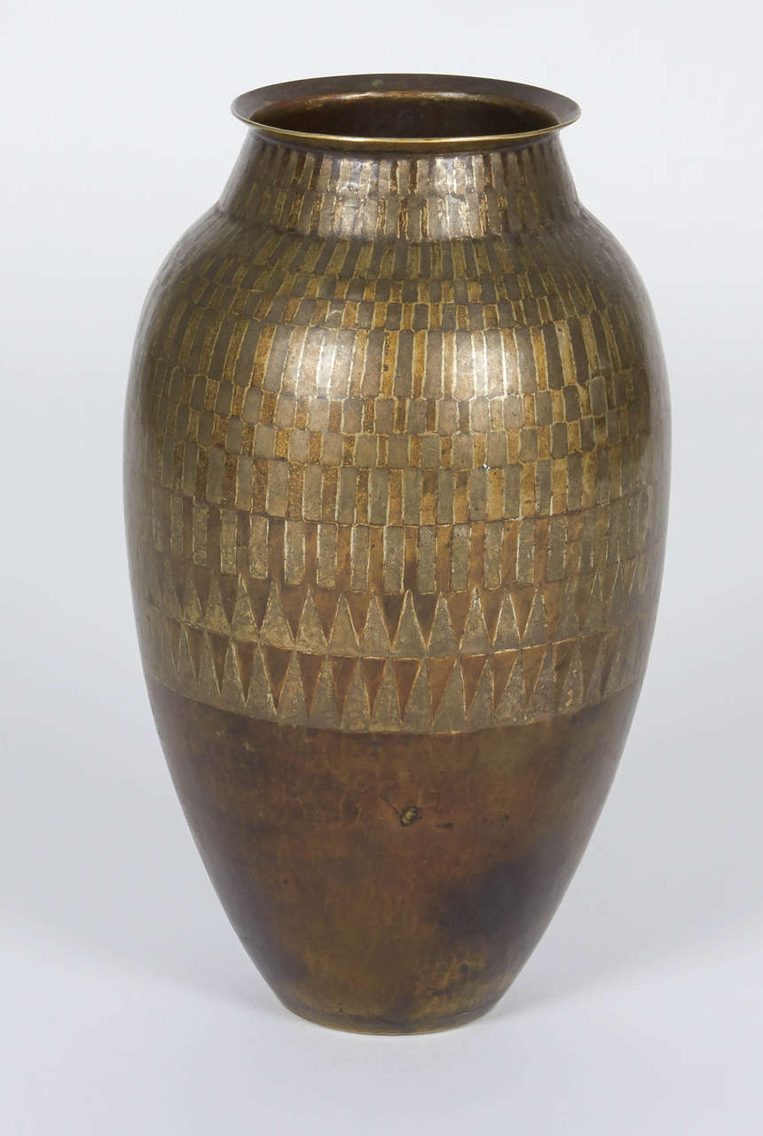 Jean Dunand Dinanderie Vase circa 1925.

Patinated copper with silver inlay.  

Inscribed:  JEAN DUNAND

Numbered:  5189

Condition:  Excellent, with an imperceptible restoration.