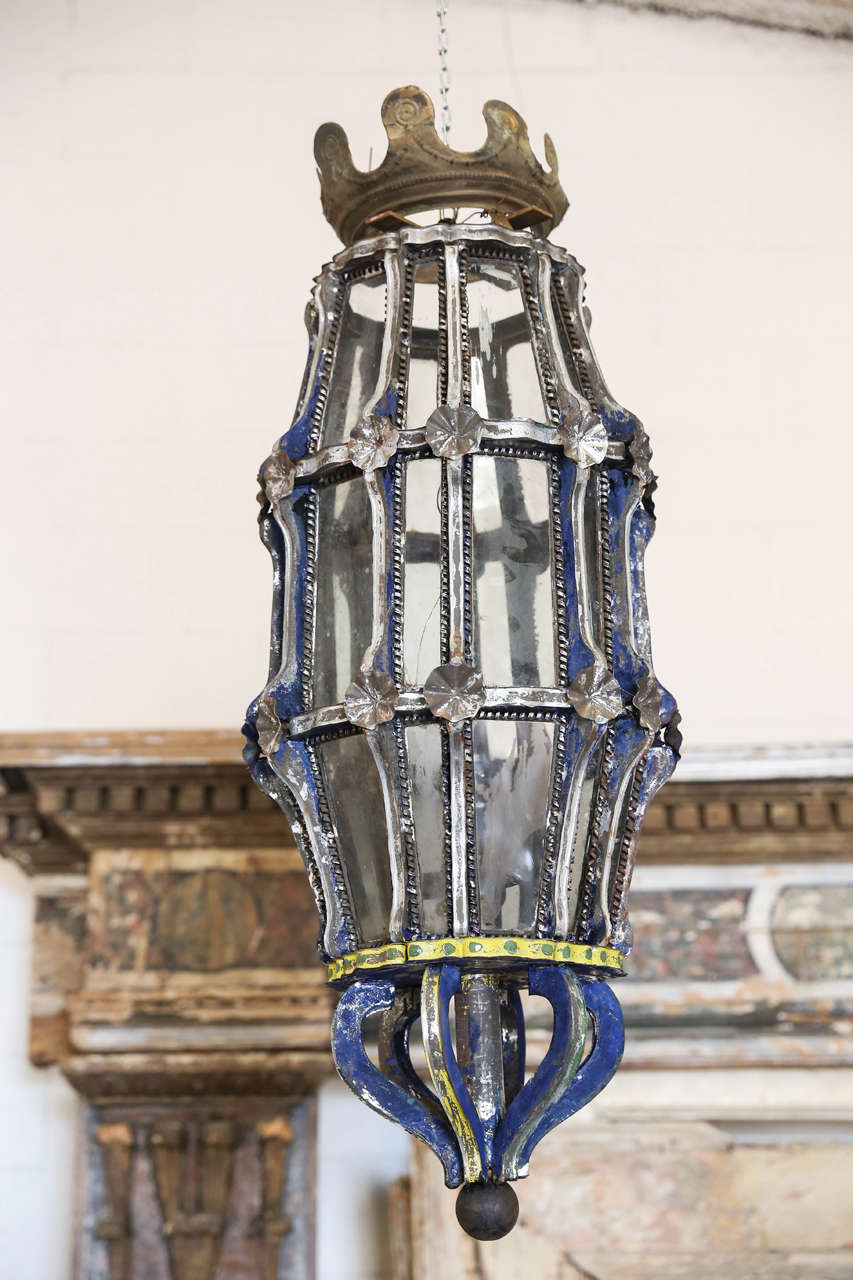 Exceptional Italian iron and metal tole painted lanterns from the late 18th-19th century with crown top very special. The glass is all intact. Needs to be wired for US standard. Two available.