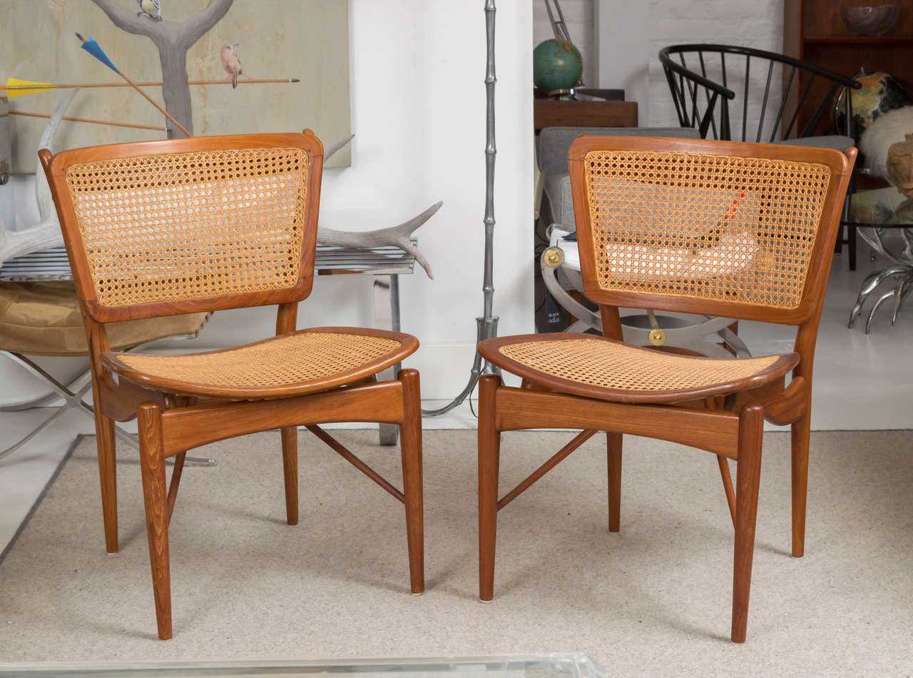 Beautiful set of four Finn Juhl for Baker NV -51 teak chairs with caned seats and back.