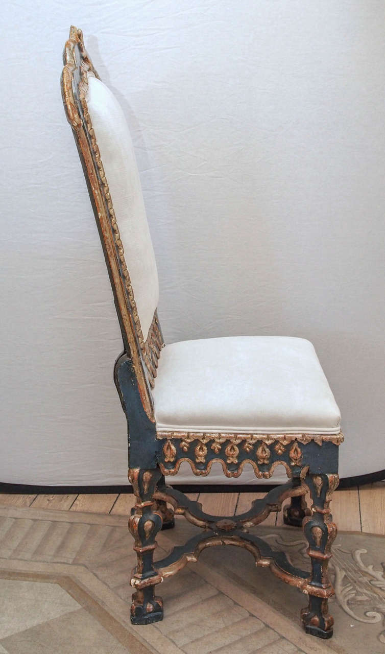 Early 19th century Italian side chairs ornately carved in the Baroque style. Beautiful detailed X-stretcher on each chair. Painted and upholstered.