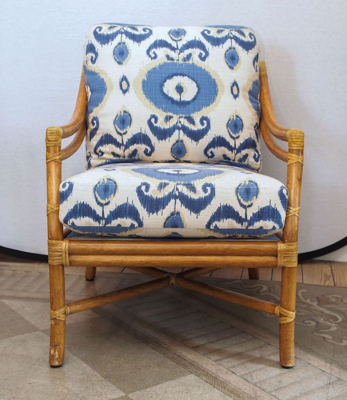 Vintage bamboo rattan lounge chair with new down blend cushions and new blue Ikat upholstery.