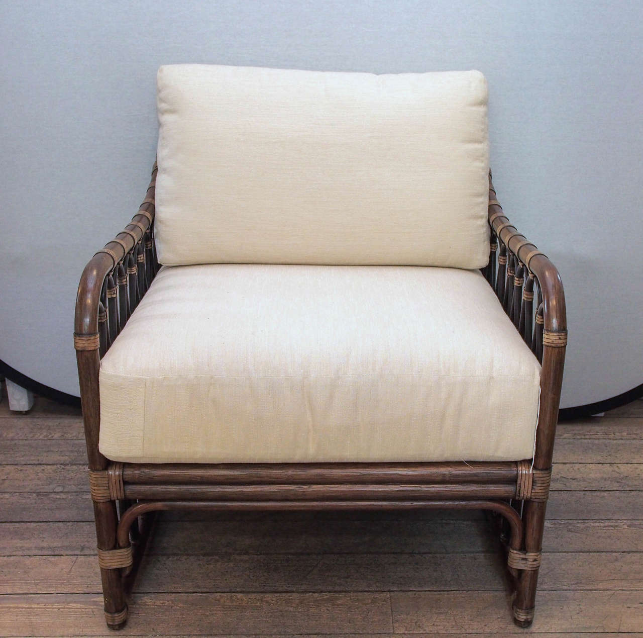 Graceful free-flowing décor, inspired by vintage colonial styling, fills the arm and back panels of the generously proportioned sona lounge chair. Leather wrapped rattan pole with cushioned seat and back. COM or custom fabric available upon request.