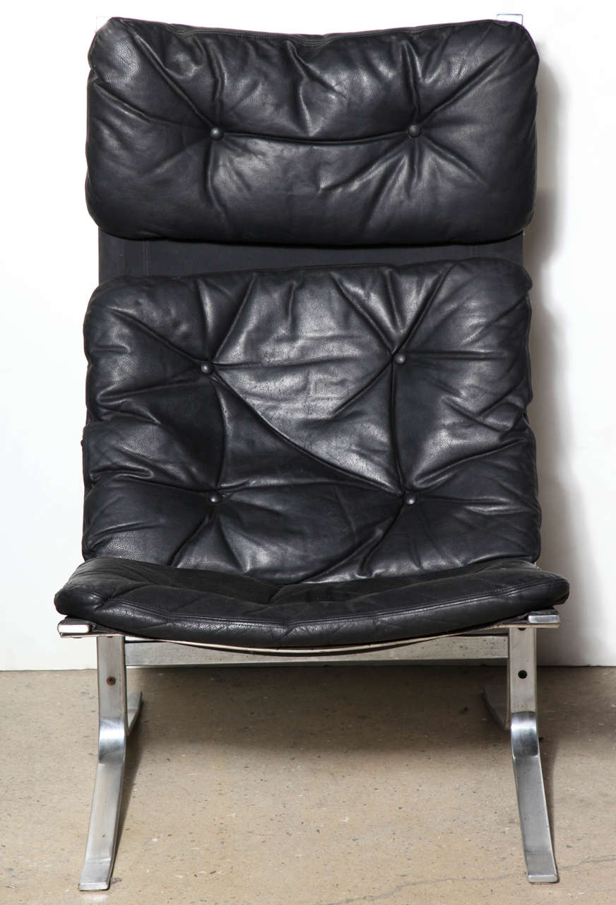 comfortable circa 1970 relaxed and flexible sling back Chrome plated Steel 
and Black Leather Scandinavian Modern Easy Chair.  Great sculptural addition to any room