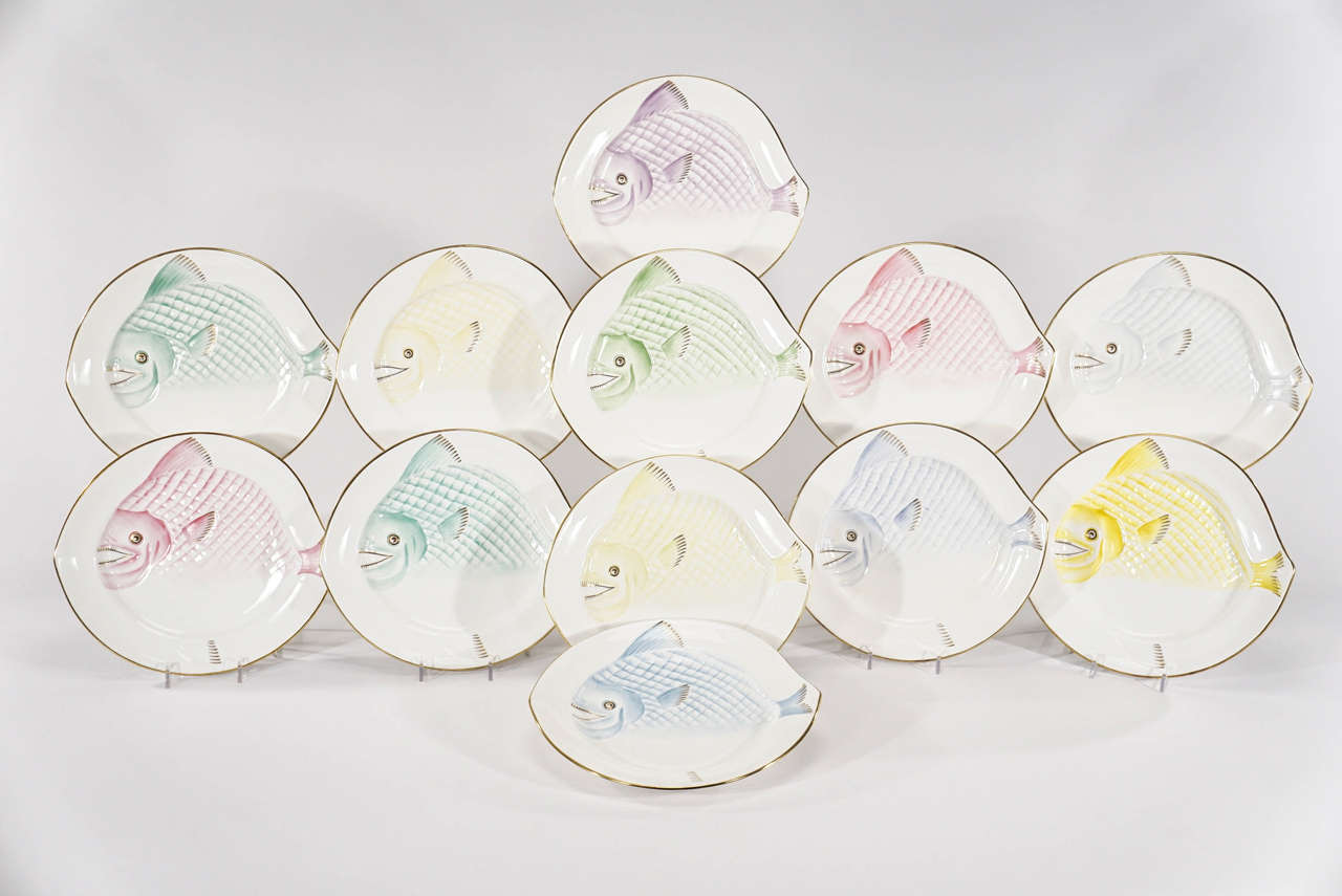 This set of 12 Royal Worcester Art Deco style porcelain plates features a full-sized raised and molded fish, ready for the table. The whimsical expressions make these the perfect conversation pieces at your dinner or a fabulous, fun display. Each