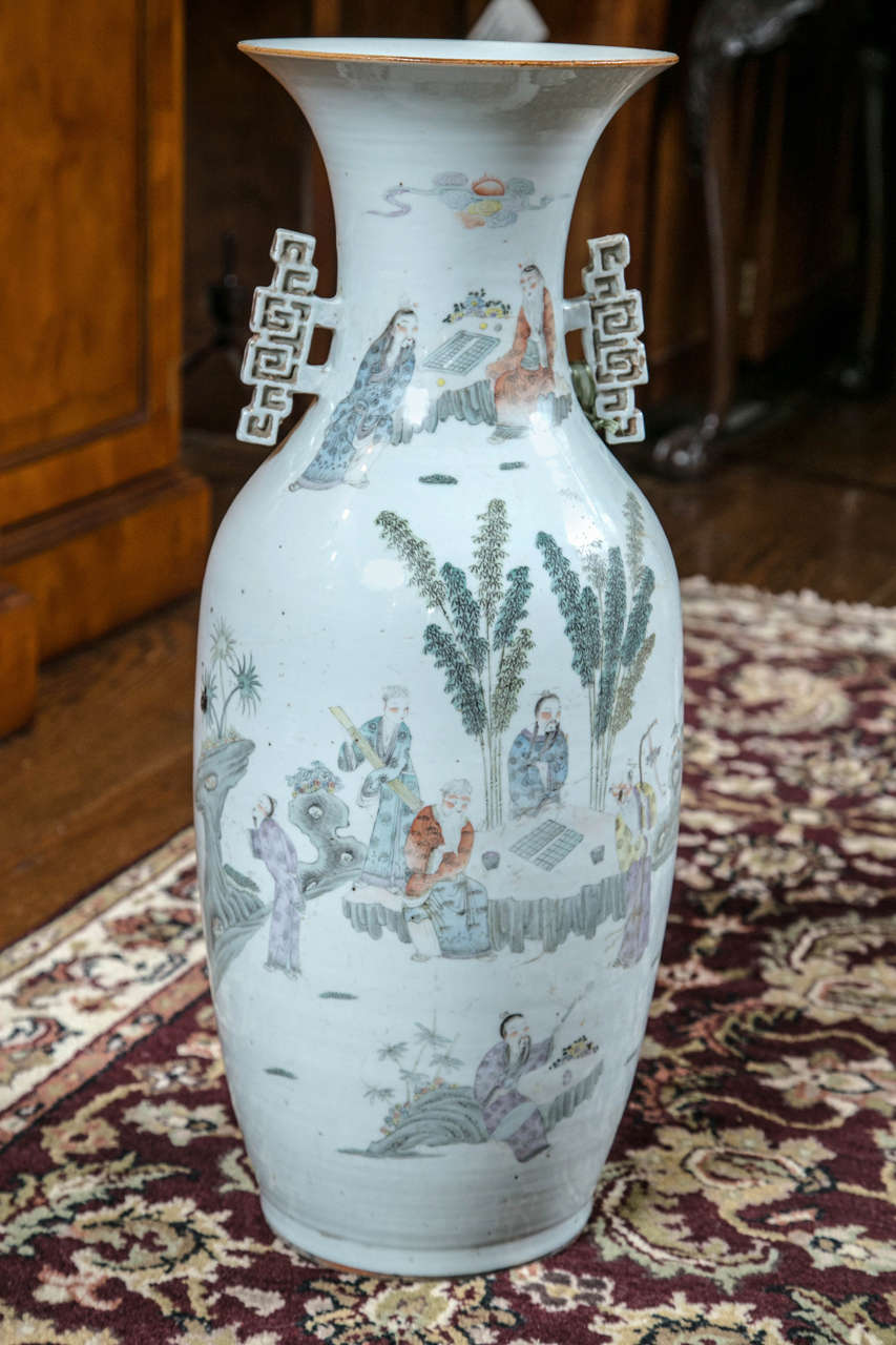 With a poem on the reverse that exhorts us to go outside and enjoy the outdoors and delicate depictions of people doing just that on the front, this outstanding antique vase has beautifully muted colors and a gentle shape.
