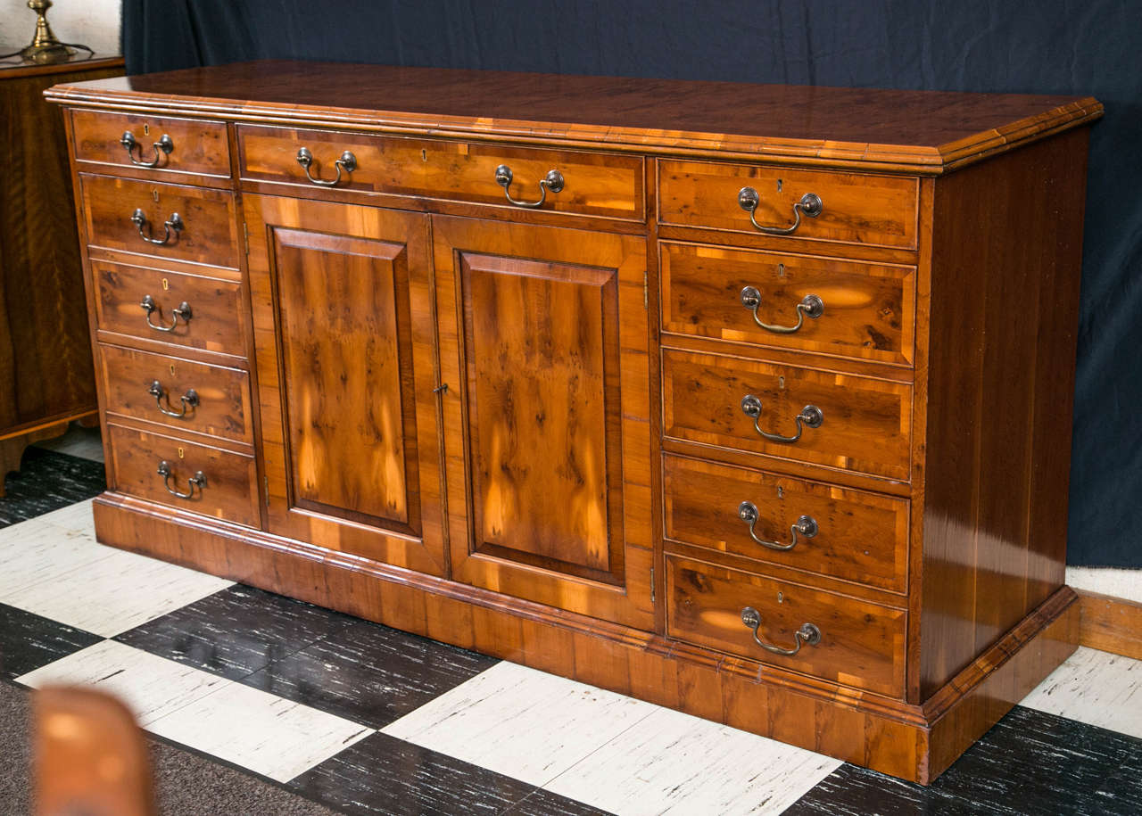 Created for us by our master craftsmen in England, this file credenza retains an old world charm while offering ample storage for the paper files we still need in this digital age. Beneath a row of narrow, beaded drawers, the double-faced file