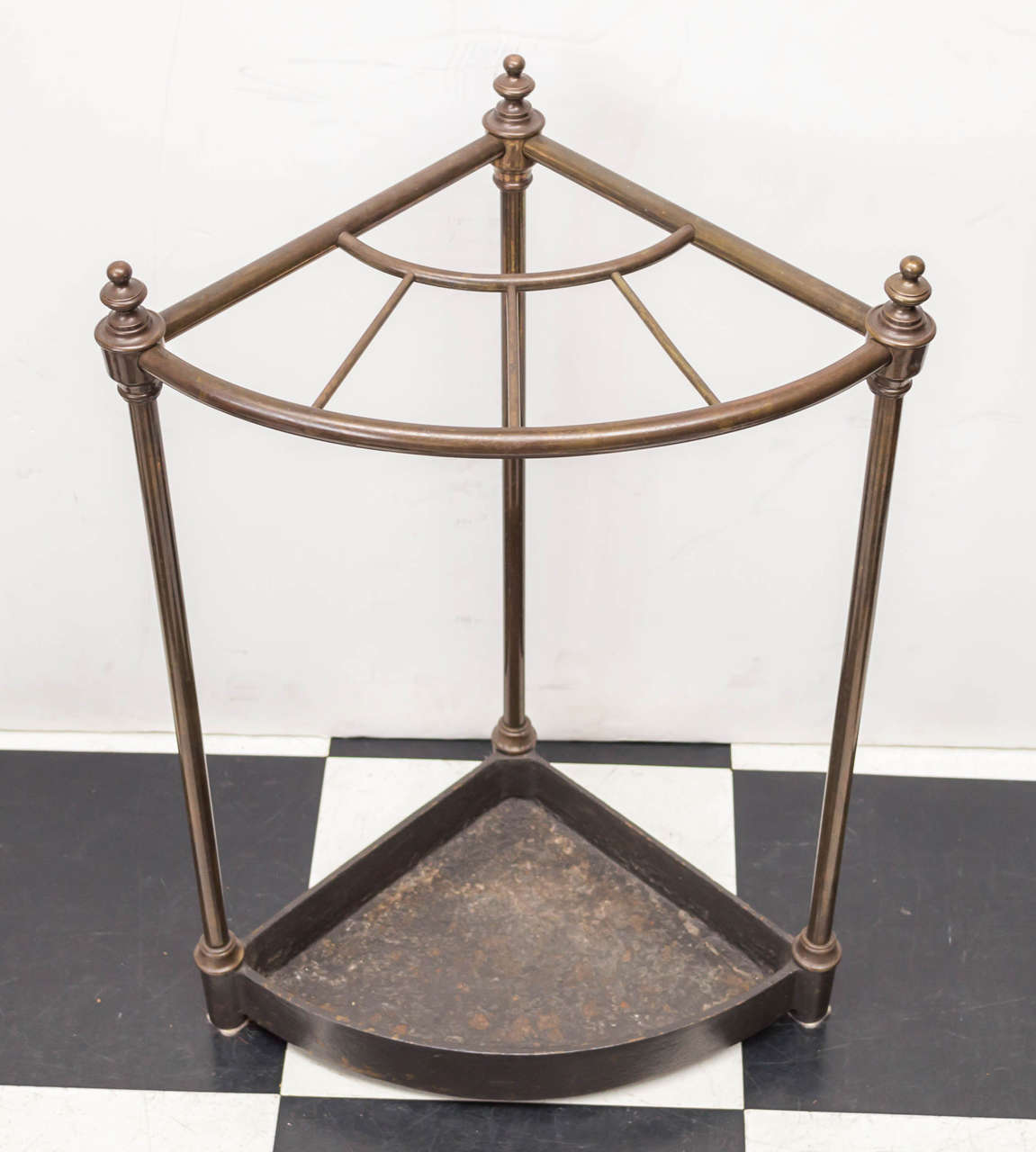 Late 19th c. English brass with cast iron base corner umbrella stand. Good distress to cast iron and patina to brass.