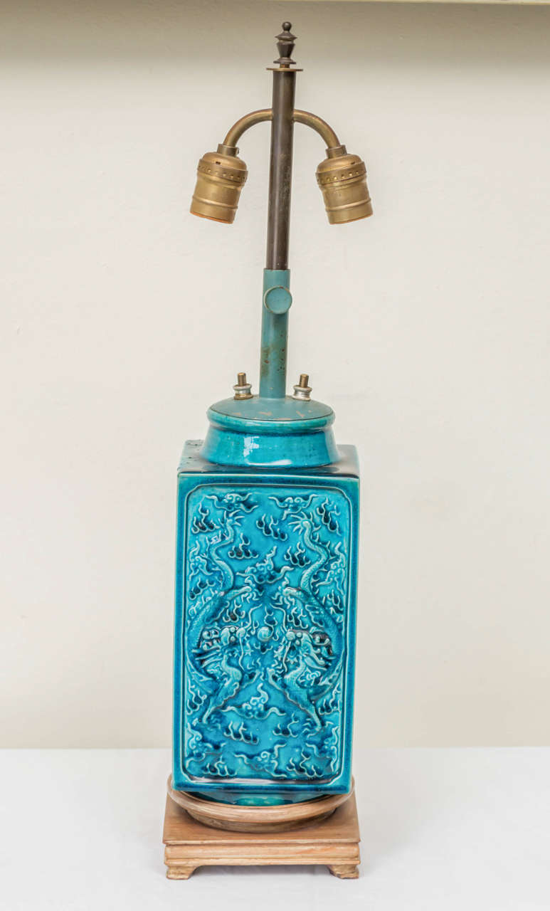 Late 19th C. Chinese dragon & phoenix vase as lamp. Turquoise glazes and custom wood stand. Dragon and phoenix relief designs on the flat panel sides. Adjustable two light cluster with separate switches. Overall height 24 to 30 inches. Circa 1880.