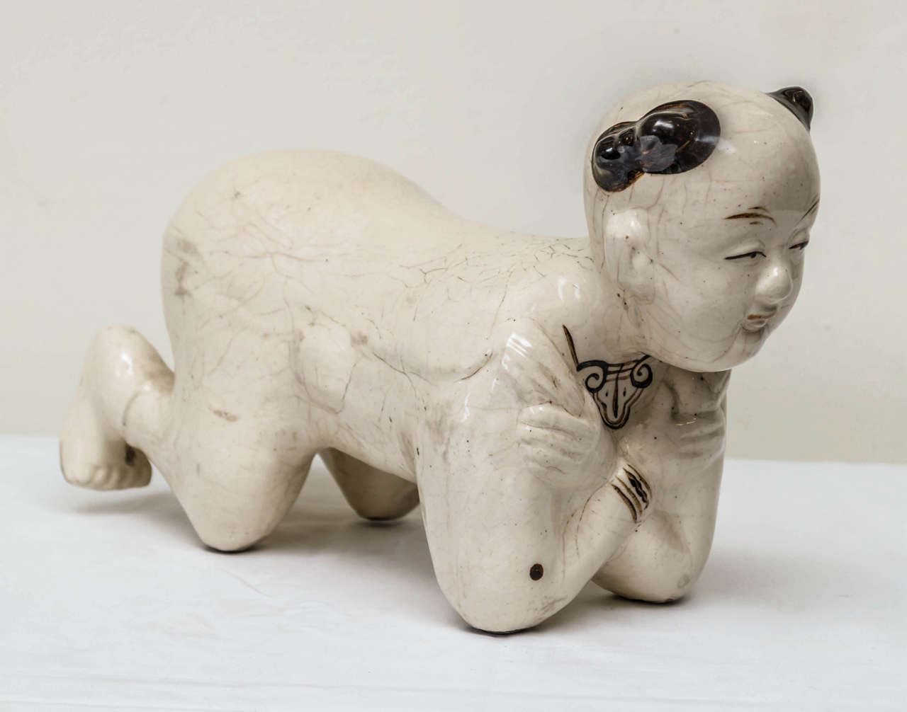 Late 19th C. Chinese Tz'u Chow stoneware pillow of a boy. Northern China Shaanxi Province. In the Ming style revived in the late 19th/early 20th century when collections of earlier works were formed, English Oriental Ceramic Society, etc.