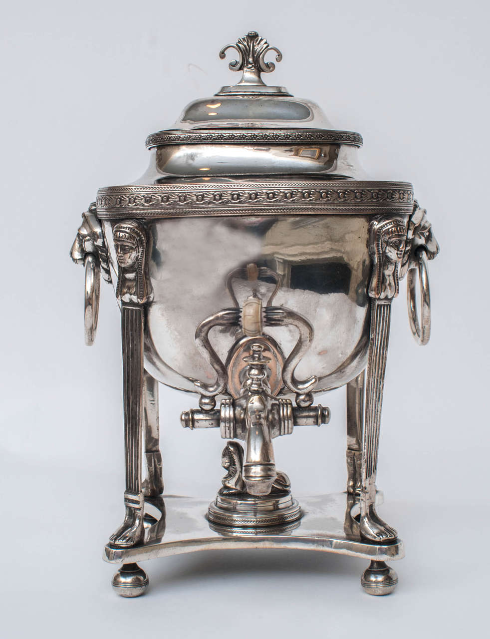 Silver on copper - original hot coals holder inside, which was used to keep the water hot - bone knob on spigot - lion heads with ring handles - sphinx on bottom and caryatid supports.