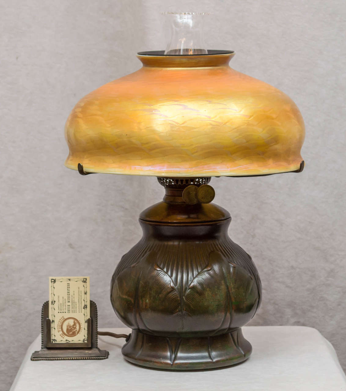 Offering here a fine example of a Tiffany Lamp. The bulbous base has all the correct parts,is signed, and has that wonderful patina that helped make Tiffany stand above the rest. The shade is 12'' in diameter,is properly signed,and free of any