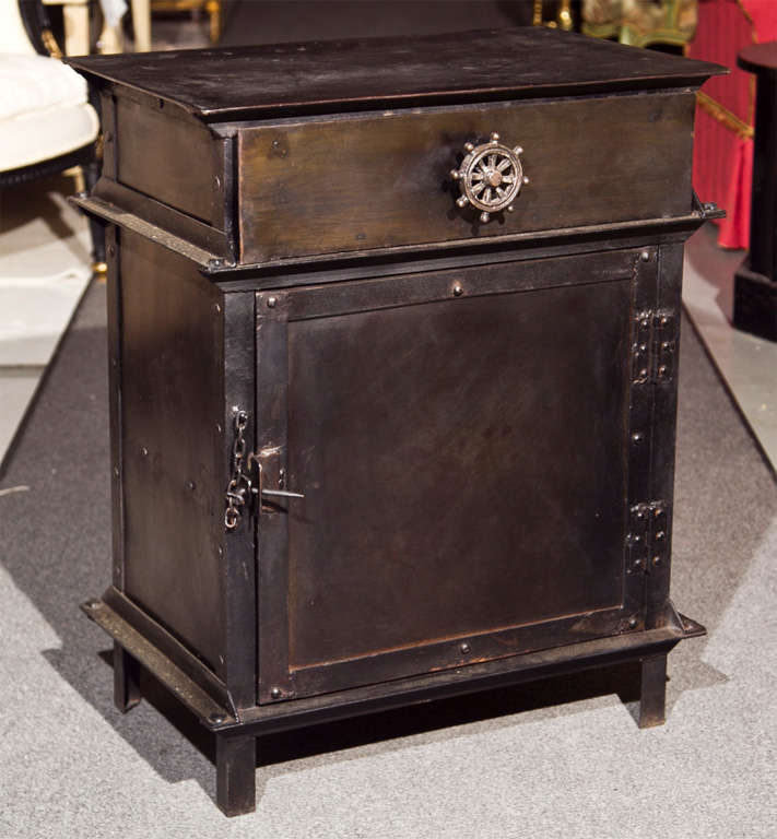 Pair of intriguing vintage industrial metal cabinets, the rectangular top over a frieze fitted with one drawer decorated with ship-wheel pull, over a single-door cabinet, raised on block feet. <br />
<br />
**Please note default picture shows