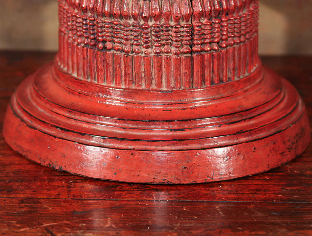 A fine turned wood offering stand (kalat) from the Intha people of Northeastern Burma. Of circular form, the bowl elevated on a conforming pedestal of sixty-two baluster posts; the surface finished in red over black lacquer. Stands such as these