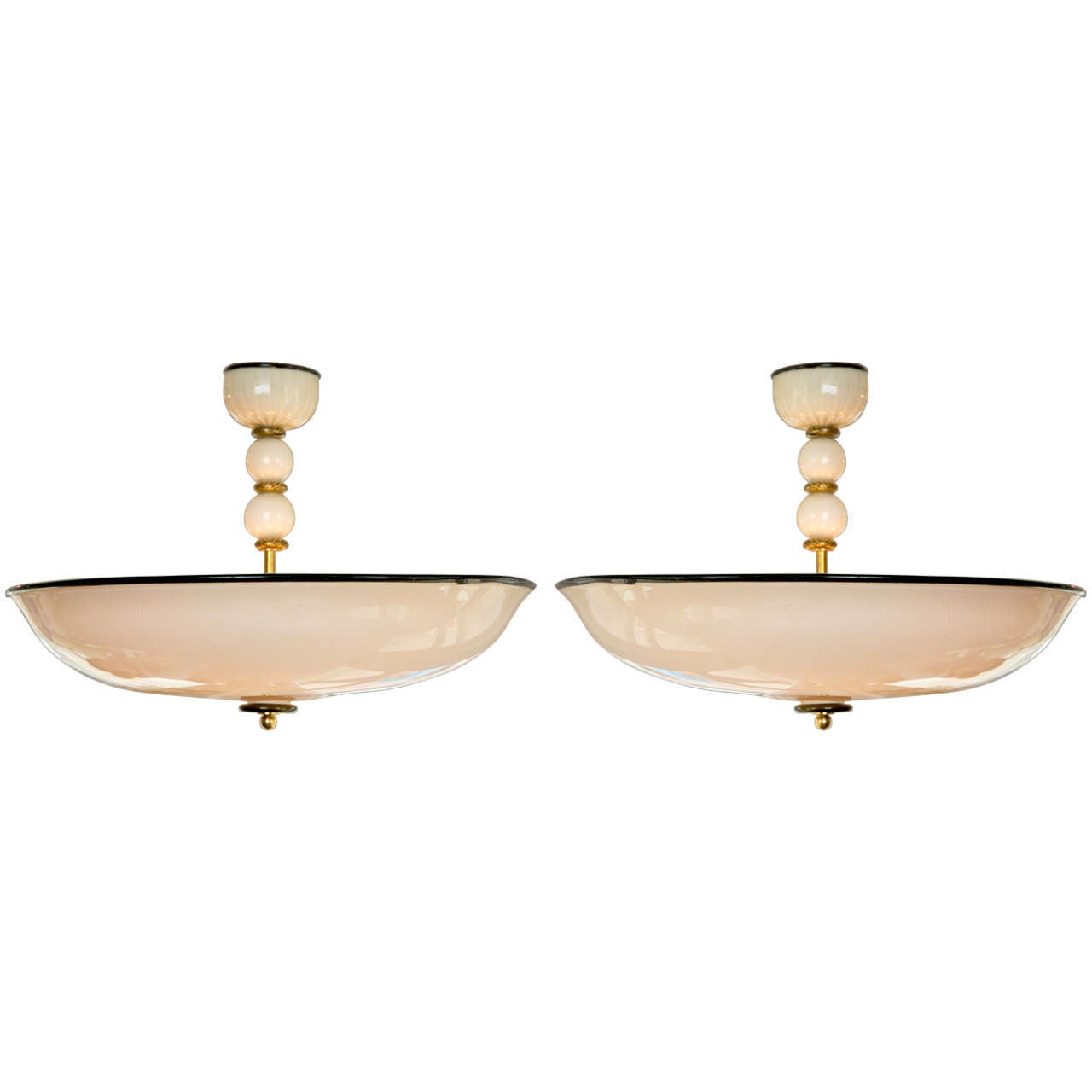 A striking mouth blown Murano Chandeliers in a pearled creme color   with black and gold detailing.  These lights are rewired for five lights up to 60 watts each.  The brass stem is only evident when eye level with the fixture.