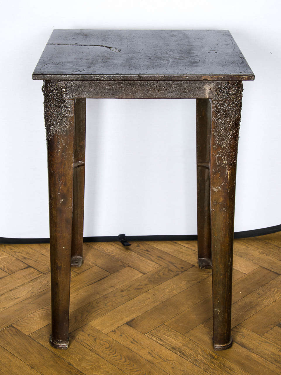 A vintage industrial workbench table in iron. This substantial, tall table has a vintage patina with some characterful markings from its previous working life.
