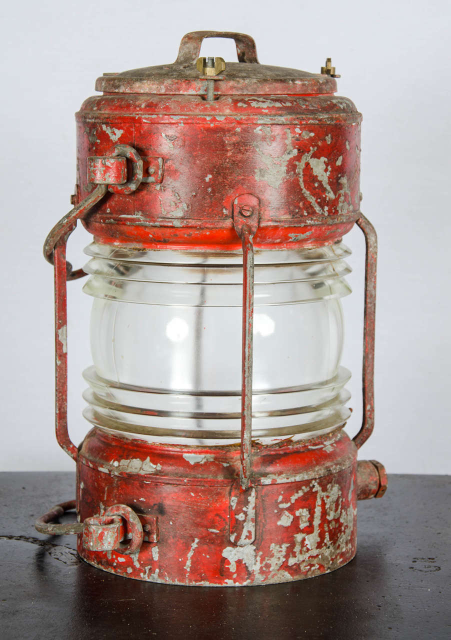 A large reclaimed ship's lantern. This vintage lantern has a weathered, sea-worn appearance. It's a great piece of industrial salvage for characterful decoration.