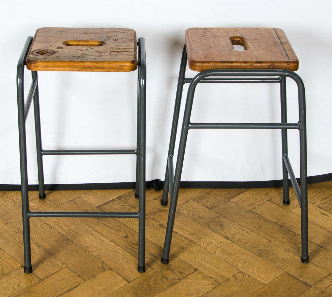 A set of 30 reclaimed retro style stools with a tubular metal bases and a characterful teak tops.
