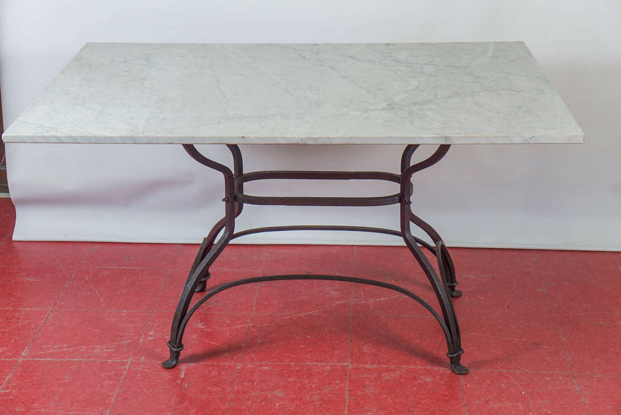 This very versatile metal base dining table can be used indoor or outdoor, kitchen or dining, patio or porch.  The table (small dining size) has a beautifully shaped wrought iron base and rectangular marble top. Top and base can be sold separately.