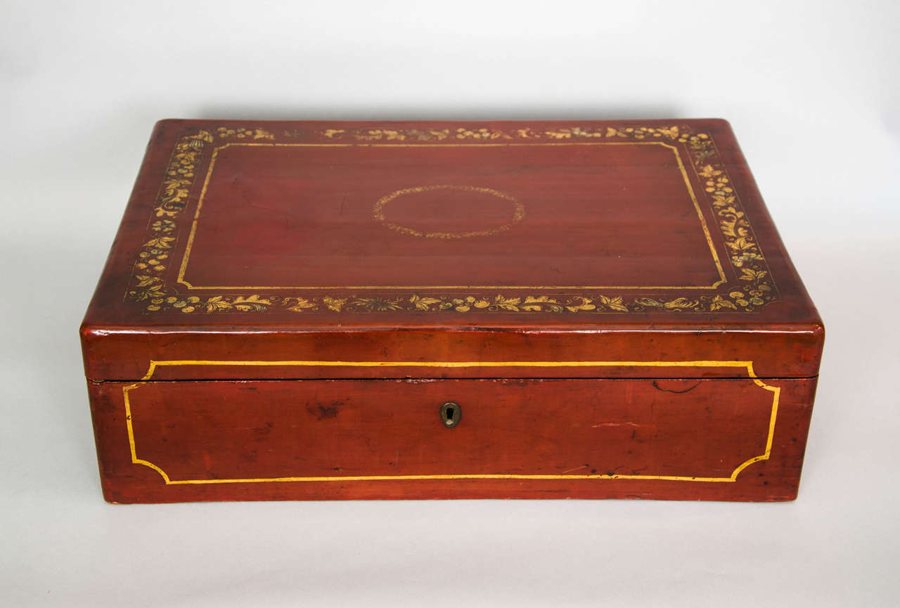 A Chinese red lacquered Regency box decorated in gold leaf borders. This box was made for the export market between 1800 and 1820 and is remarkably good condition considering the delicate nature of lacquered tropical soft wood. The insides of the