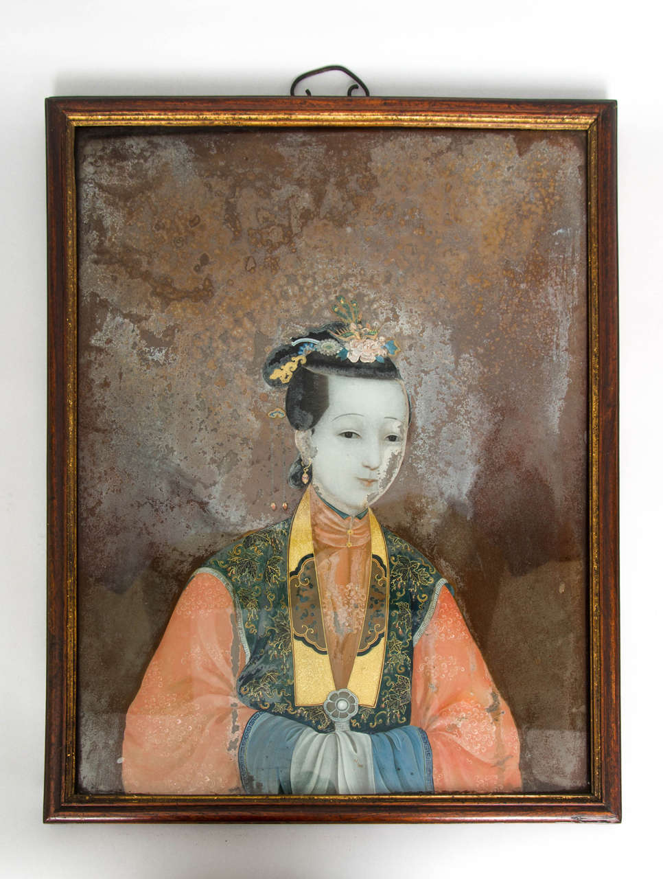 A pair of large Chinese Export reverse glass portrait pictures, one panel depicting a woman of rank, the other her husband, probably a dignitary in their original frames. Their scale is unusually large and are exceptionally fine. The pictures retain