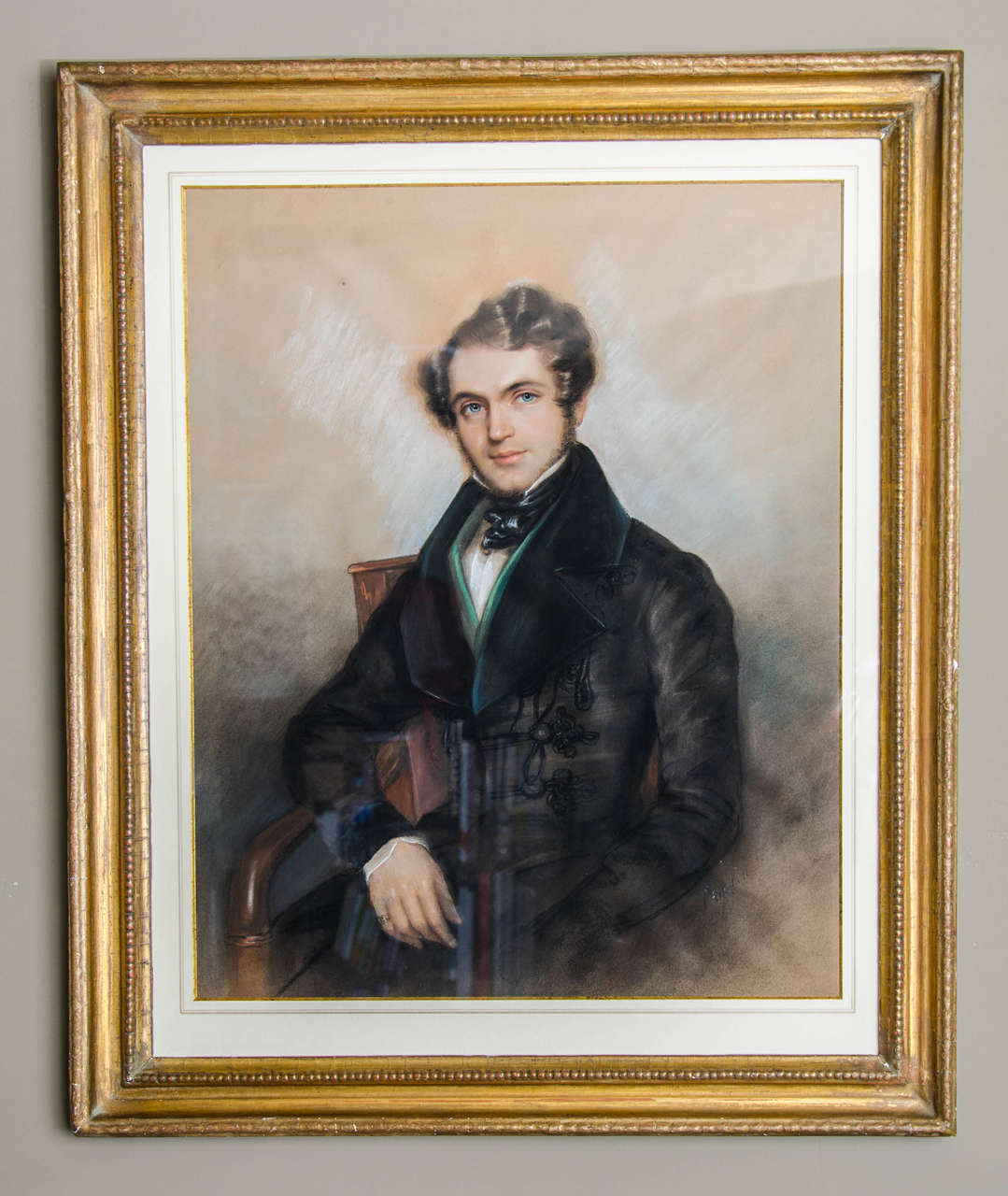 An extremely striking pastel portrait of a handsome young man by Guelin Paulin. The execution by the artist is very precise and beautifully drawn. The young man has green eyes which he fixes very firmly on the viewer. He is dressed in a black frock