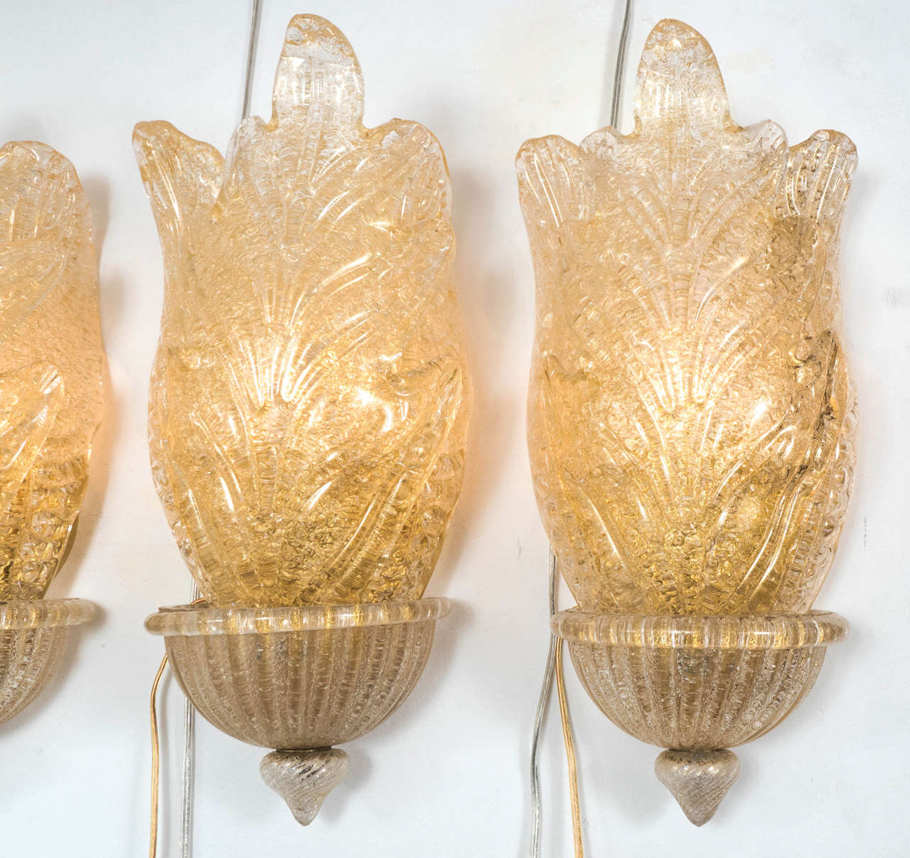 Pair of Murano glass sconces composed of clustered leaf elements featuring inclusive air bubbles and gold flecks.