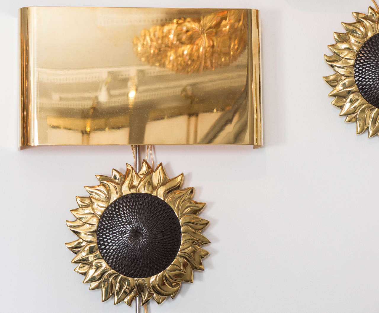 Pair of brass and bronze sconces featuring sunflower design by Maison Charles.