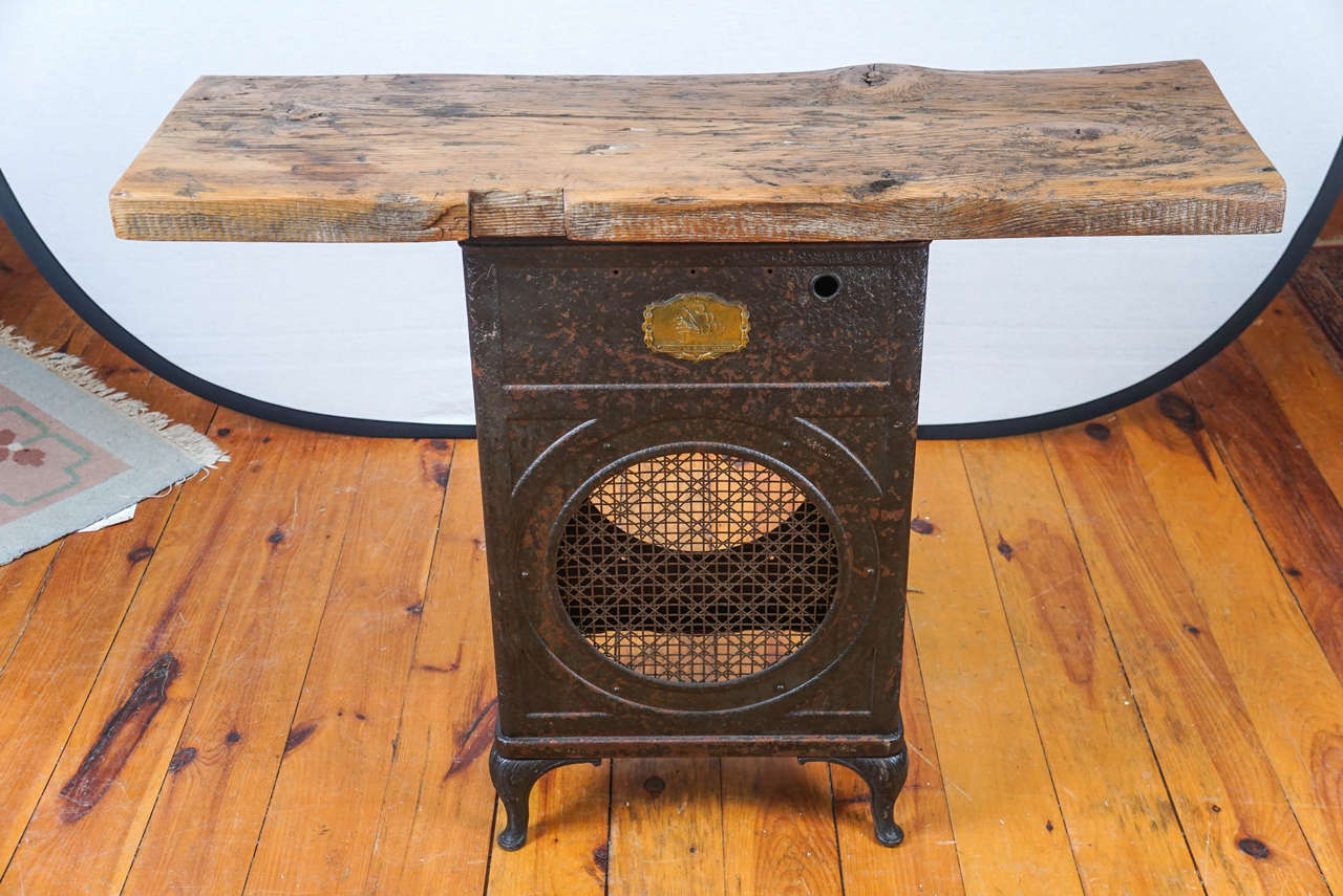 The base of this industrial table is from a 1928 Atwater Kent Radio. A picture of the radio will come with the customer who buys this piece . The other side has the dials from the radio. The guts were removed many years ago, setting the stage for a