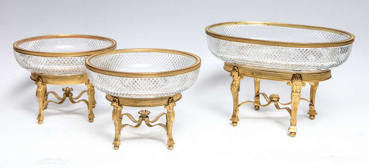 A magnificent three-piece garniture set of gilt bronze-mounted cut crystal centerpieces of fine detail and quality by Baccarat, Paris, 19th century.