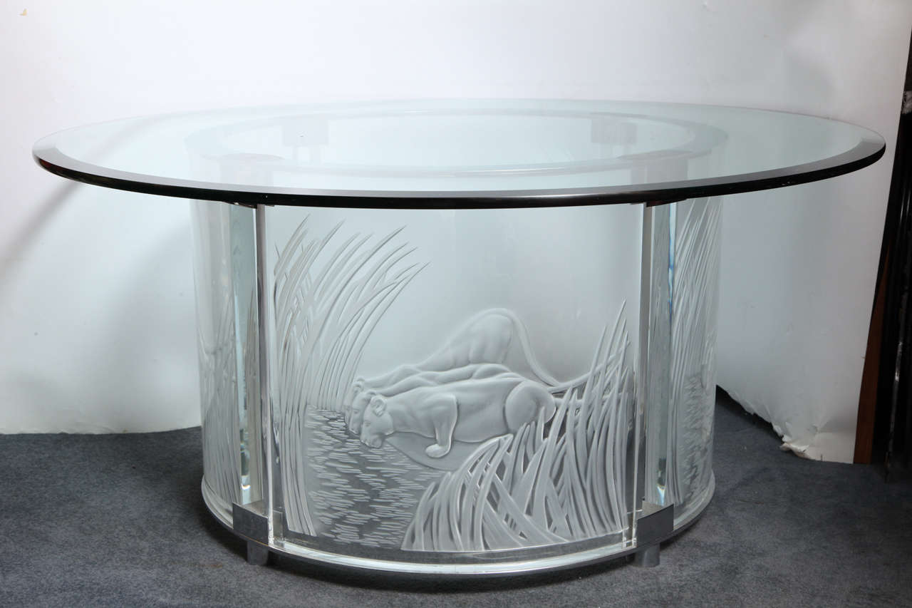 French Art Deco style Lalique frosted & clear crystal with a silver chrome mounted round circular cocktail table with panels depicting Leopards in the forest, signed by Lalique.
France, Circa 1990's