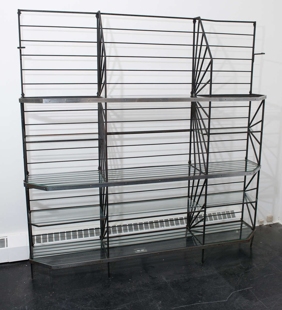 This is a stunning bakers/ display rack from the Art Deco period
with fitted glass shelves and chrome metal banding. A sculptural
and geometric beauty that combines form and function.