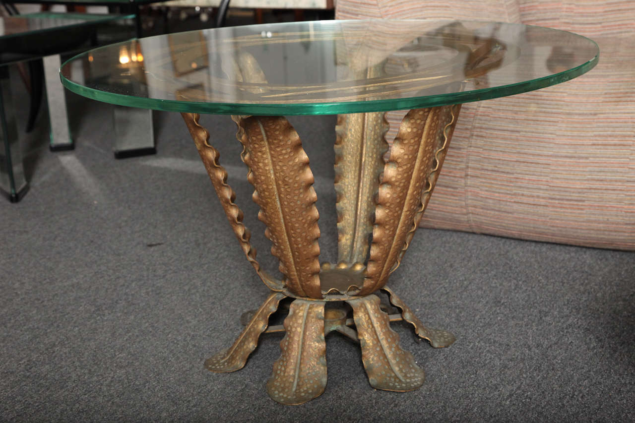 Exciting gilded and hand-forged iron Art Deco cocktail table with top in glass, made in 1938 in Torino, Italy.
Unusual form, never saw before, amazing details and great quality.
 