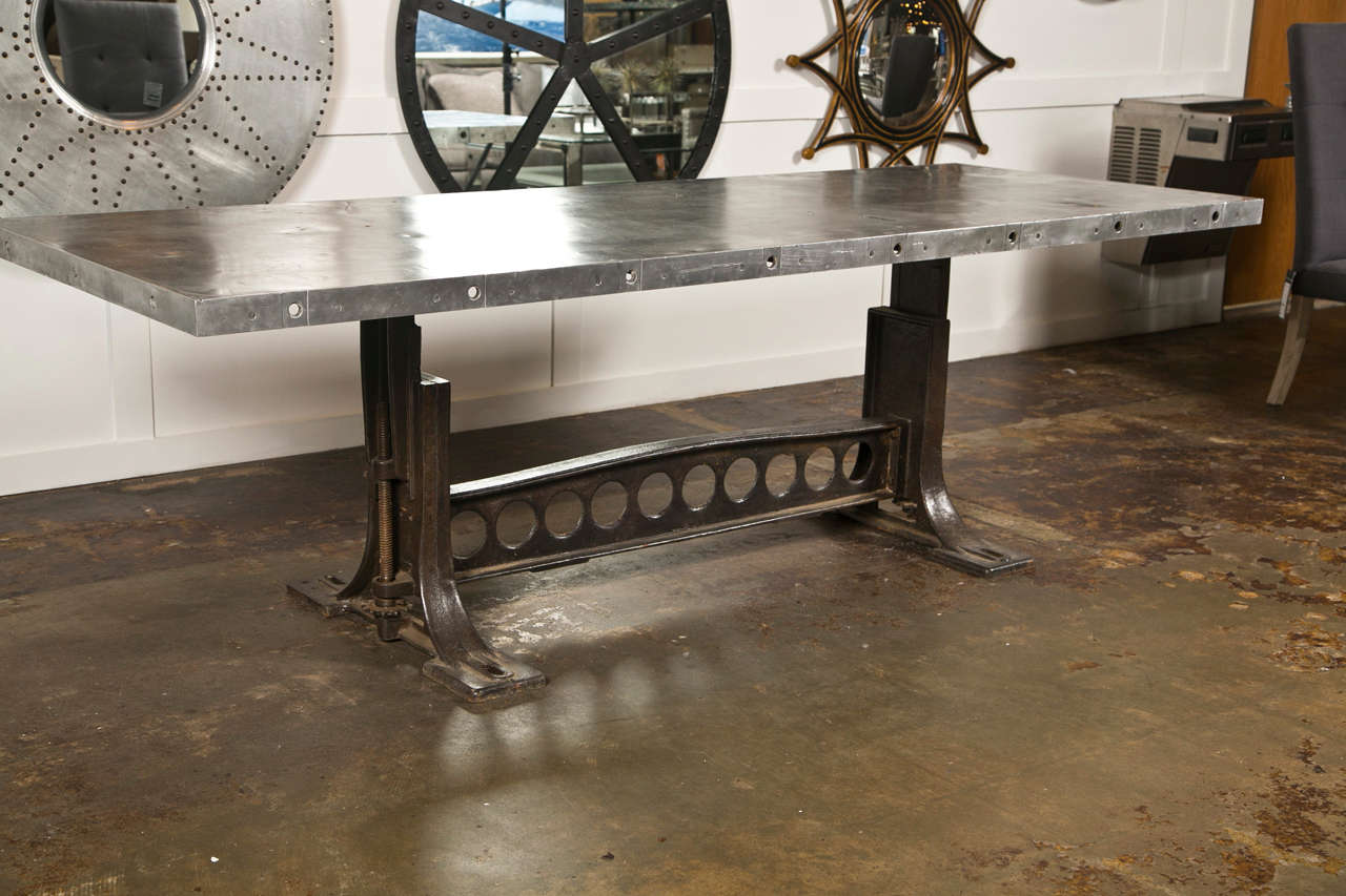 Industrial style dining table, the base from a mid century cast iron stroke sander table, and the top constucted from vintage airplane aluminum