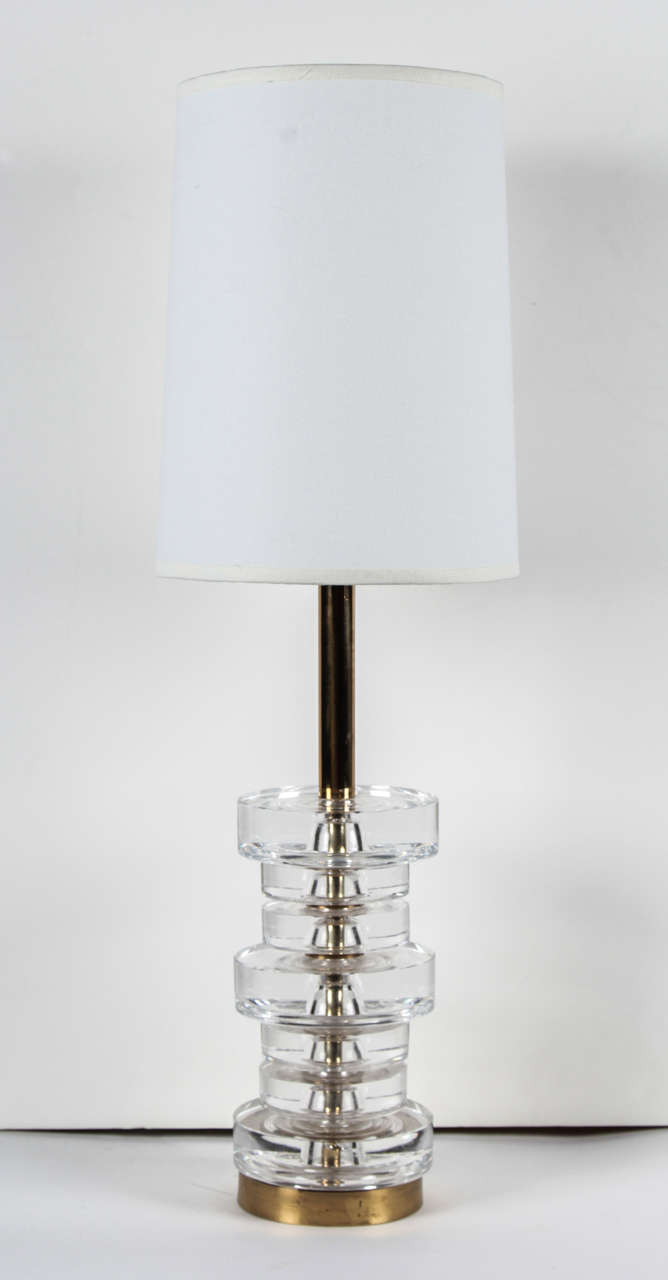 Fantastic pair of stacked crystal disc lamps on a brass bases by Orrefors. Rewired for use in the USA.