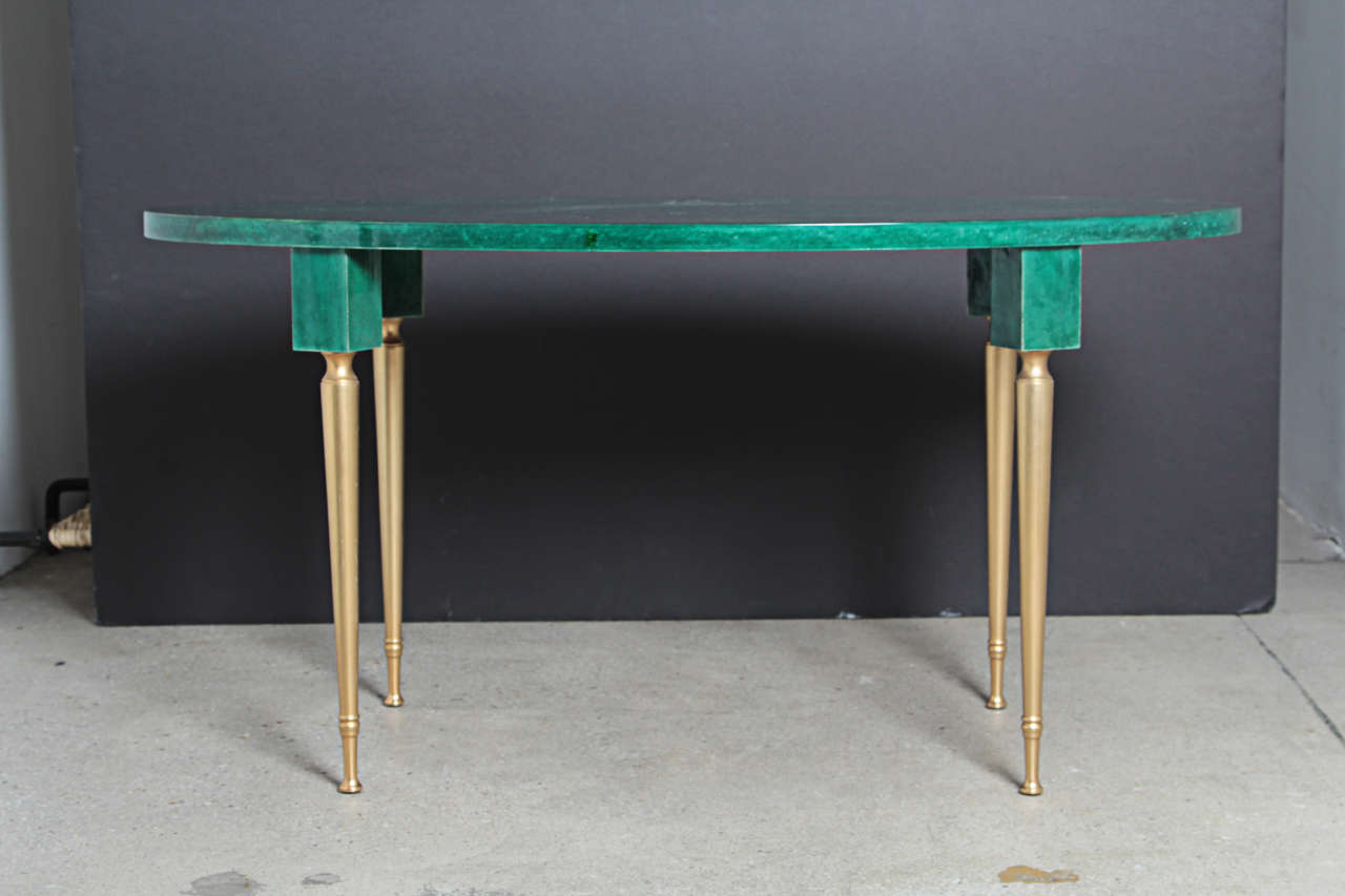 Surprising green parchment coffee table by Aldo Tura. 
The item is signed with a sticker of the artist (Standard way of working of Aldo Tura). 

The top of the table is in green parchment and the lower parts of the feet are in golden bronze. 
