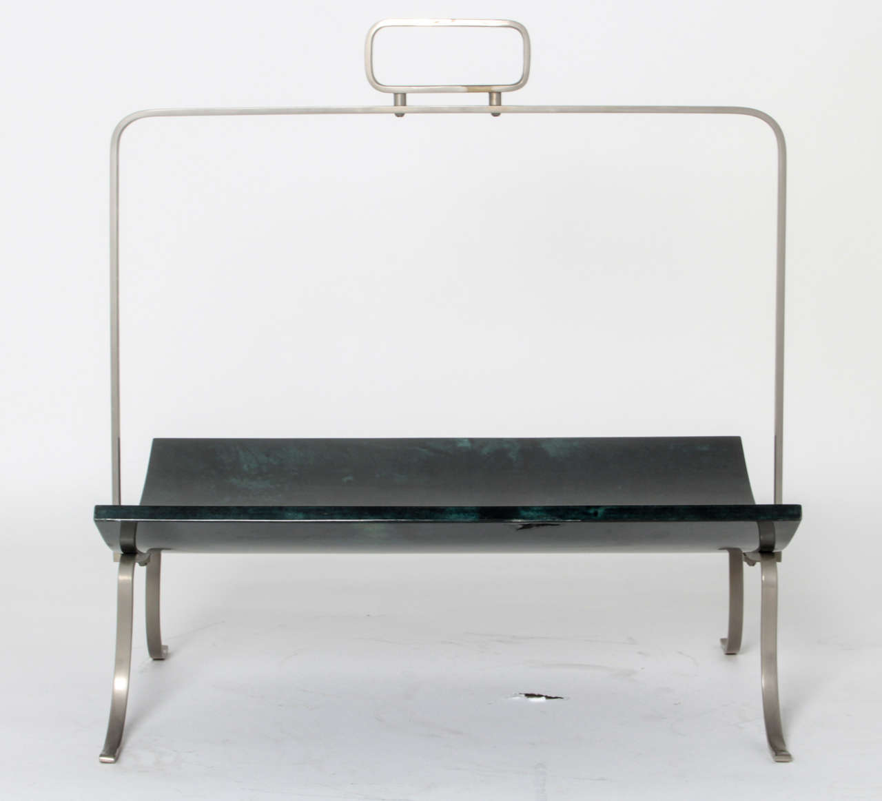 Elegant newspaper rack designed and signed by Aldo Tura.
Wood plated with deep blue goatskin and nickeled metal.