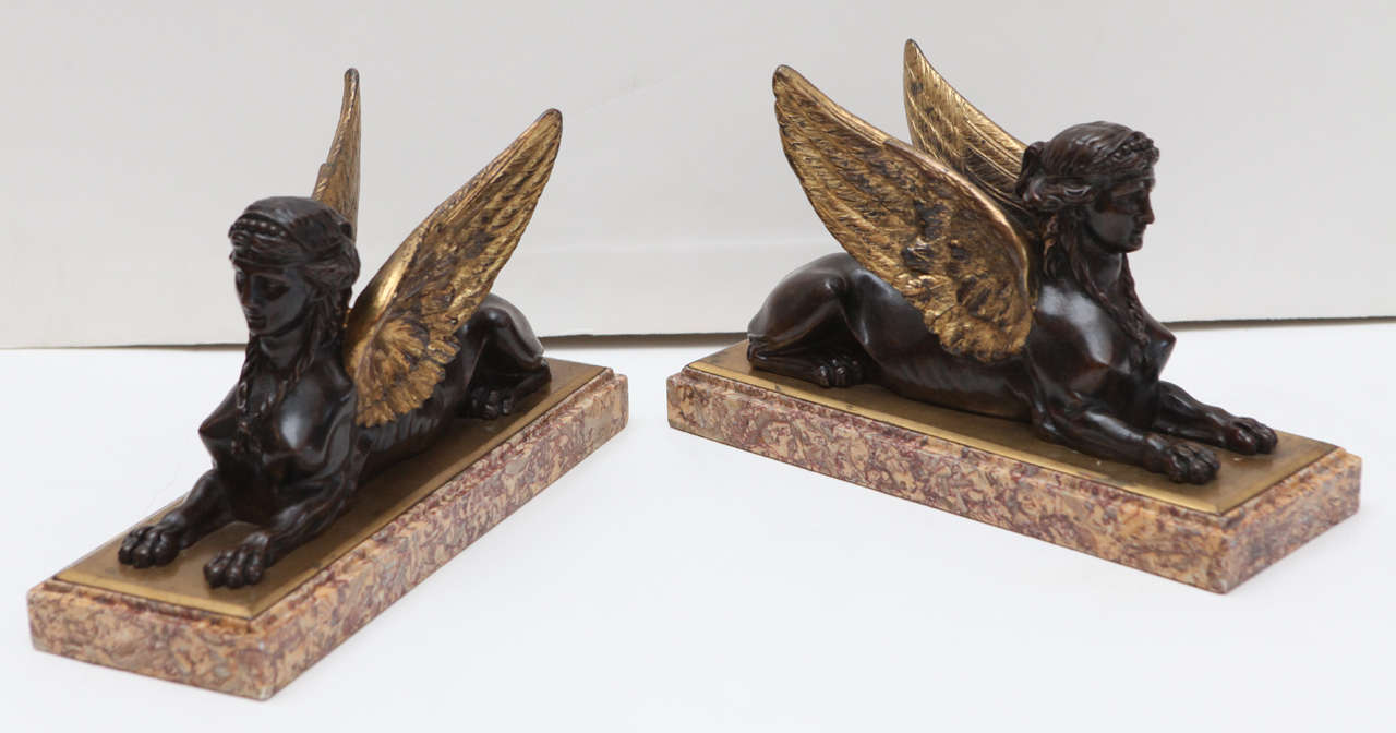 Pair of exceptional, hand-cast, French, parcel-gilt bronze sphinxes on newer, beveled marble bases.