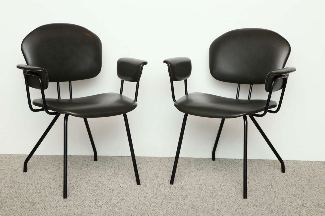 Pair of architectural armchairs by MIM. Graphic frames of black painted metal with upholstered seats, backs and armrests. Great forms, signed on backs. 