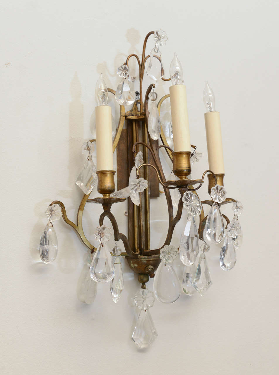 Pair of sconces, each having bronze lyre shaped frame, three scrolling candlearms; the entire fixture draped with crystal drops.