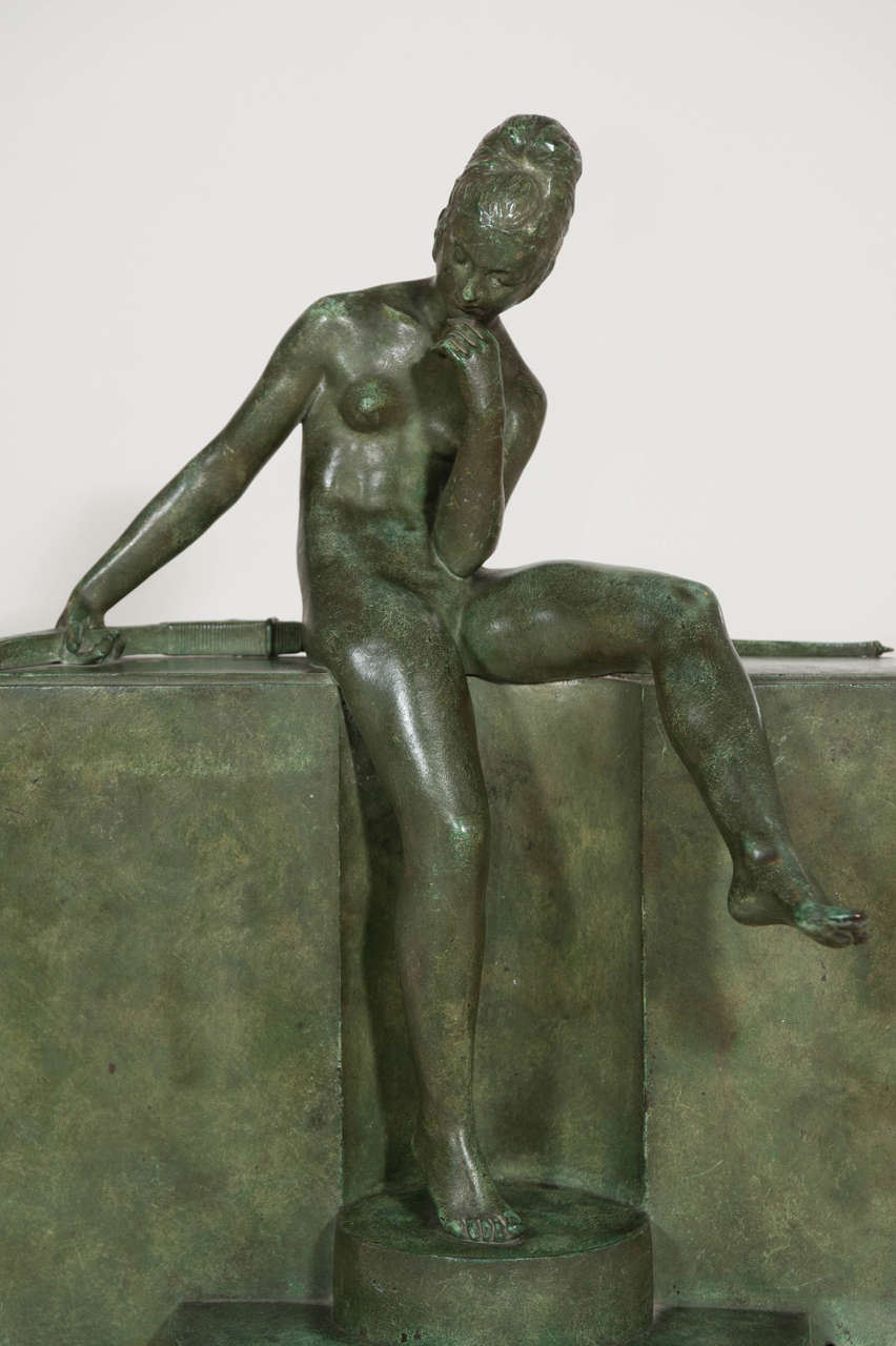 Green patinated bronze sculpture of a seated amazon by Ary Bitter (1883-1973) and cast by Susse Freres Paris