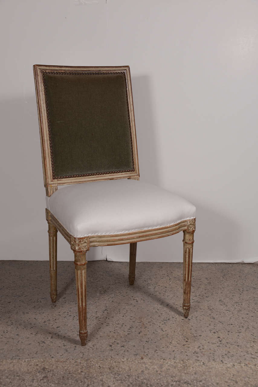 Set of six Louis XVI dining chairs in original paint. Chairs have a wonderful aged patina. Seats have new springs and webbing, covered in new ticking. Inside backs in existing mohair. Outside backs are covered in existing French linen check.